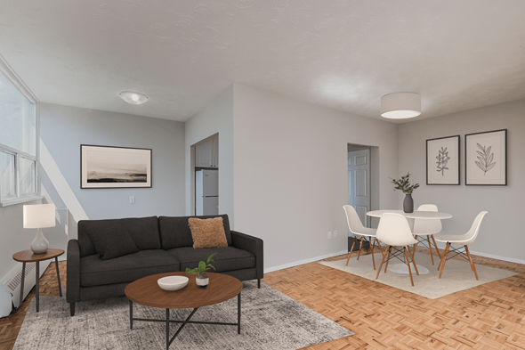Hamilton apartment for rent - A living room with a grey couch, a brown coffee table, and a dining table with chairs.