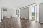 Hamilton apartment for rent - A large empty room with wooden floors and white walls.