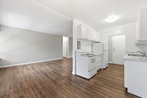 Hamilton apartment for rent - A kitchen with white appliances and wooden floors.