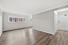 Hamilton apartment for rent - A room with wooden floors and a white door.