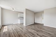 Hamilton apartment for rent - A room with wood flooring and a ceiling fan.