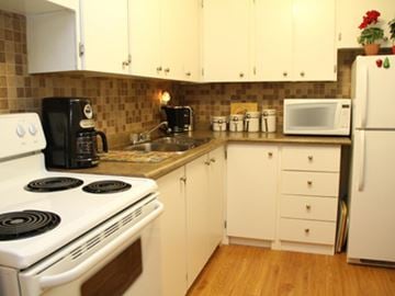 Hamilton apartment for rent - A kitchen with a white stove and white cabinets.
