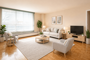 Hamilton apartment for rent - A living room with a grey sofa, a white coffee table, and a grey armchair.