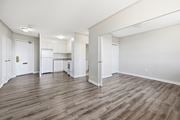 Hamilton apartment for rent - A spacious room with wooden flooring and white walls.
