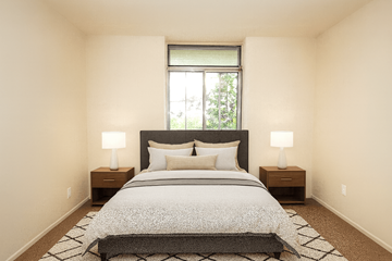 Hamilton apartment for rent - A bedroom with a large bed and two lamps.