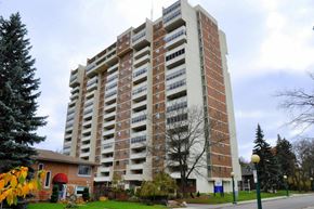 Kitchener apartment for rent - A large brick building with many windows and balconies.