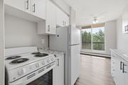 Hamilton apartment for rent - A white kitchen with a stove and refrigerator.
