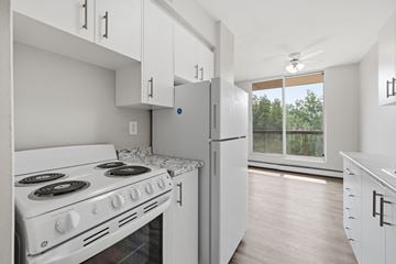 Hamilton apartment for rent - A white kitchen with a stove and refrigerator.