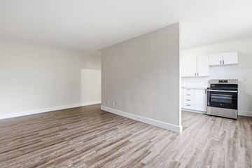 Welland apartment for rent - A kitchen with white cabinets and a stove top oven.