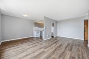 Hamilton apartment for rent - A kitchen with a refrigerator, microwave, and oven is visible through a doorway.