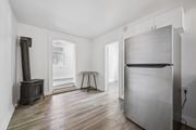 Kitchener apartment for rent - A kitchen with a wood stove and a refrigerator.