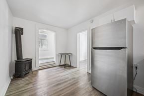Kitchener apartment for rent - A kitchen with a wood stove and a refrigerator.