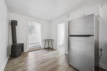 Kitchener apartment for rent - A kitchen with a wood stove and a refrigerator.