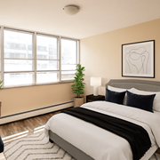 Stoney Creek apartment for rent - A bedroom with a large bed and a potted plant.