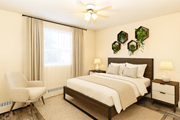 Hamilton apartment for rent - A bedroom with a bed, chair, and two lamps.