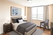 Stoney Creek apartment for rent - A bedroom with a large bed, a nightstand with a lamp, and a chair by the window.