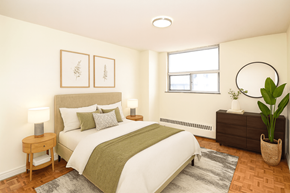 Kitchener apartment for rent - A bedroom with a bed, nightstand, and a plant.