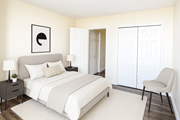 St. Catharines apartment for rent - A bedroom with a bed, chair, and a wall art.