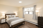 Kitchener apartment for rent - A bedroom with a large bed and two nightstands.