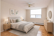 Hamilton apartment for rent - A bedroom with a bed, nightstand, and a window.