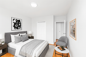 Hamilton apartment for rent - A bedroom with a bed, a chair, and a painting on the wall.
