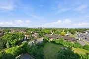 Hamilton apartment for rent - A view of a green field with a building in the background.