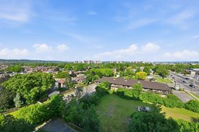 Hamilton apartment for rent - A view of a green field with a building in the background.