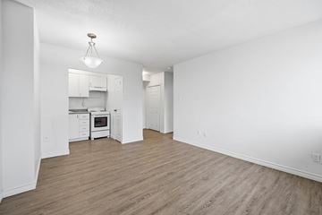 Hamilton apartment for rent - A kitchen with white cabinets and a wooden floor.