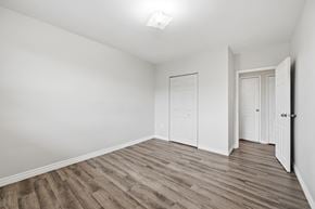Hamilton apartment for rent - A room with wooden flooring and white walls.