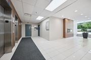 Kitchener apartment for rent - A hallway with a grey carpet and a blue door.
