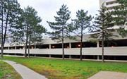 Hamilton apartment for rent - A building with a parking garage in front of it.