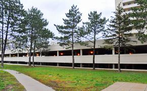 Hamilton apartment for rent - A building with a parking garage in front of it.