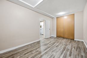 Hamilton apartment for rent - A room with a wooden floor and a white door.