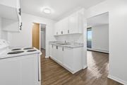 Hamilton apartment for rent - A kitchen with white cabinets and a white stove top oven.