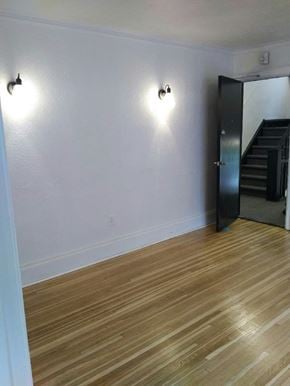 Kitchener apartment for rent - A room with wooden floors and two wall lights.