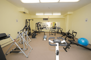Hamilton apartment for rent - A gym with a variety of equipment including treadmills, weights, and exercise balls.