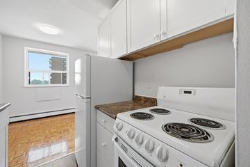 Hamilton apartment for rent - A white stove with a window above it in a kitchen.