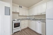 Hamilton apartment for rent - A white kitchen with a stove and cabinets.
