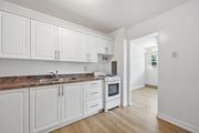 Hamilton apartment for rent - A kitchen with white cabinets and a brown countertop.