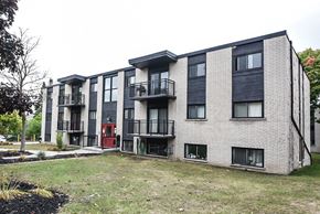 Waterloo apartment for rent - Apartment building with balconies and doors in front.
