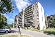 St. Catharines apartment for rent - A tall residential building with a parking lot in front.