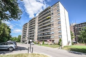 St. Catharines apartment for rent - A tall residential building with a parking lot in front.