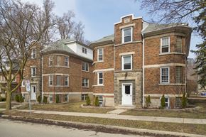 Kitchener apartment for rent - A red brick building with a white door and windows.