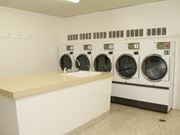 Hamilton apartment for rent - A laundromat with a row of washers and dryers.
