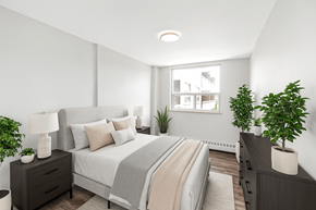 Dundas apartment for rent - A bedroom with a bed, nightstands, and plants.