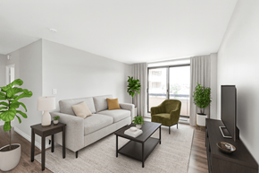 Dundas apartment for rent - A living room with a grey couch, a green armchair, a coffee table, and a television.
