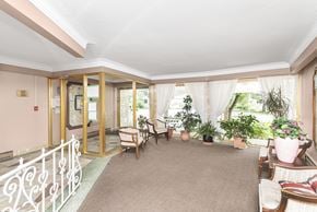 Stoney Creek apartment for rent - A living room with a white railing and a glass door.