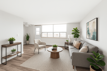 Hamilton apartment for rent - A living room with a grey couch, a white chair, a wooden coffee table, and a painting on the wall.