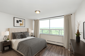 Hamilton apartment for rent - A bedroom with a large bed and a window overlooking the ocean.