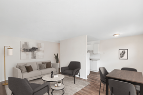Hamilton apartment for rent - A living room with a grey couch, a white coffee table, and a grey chair.